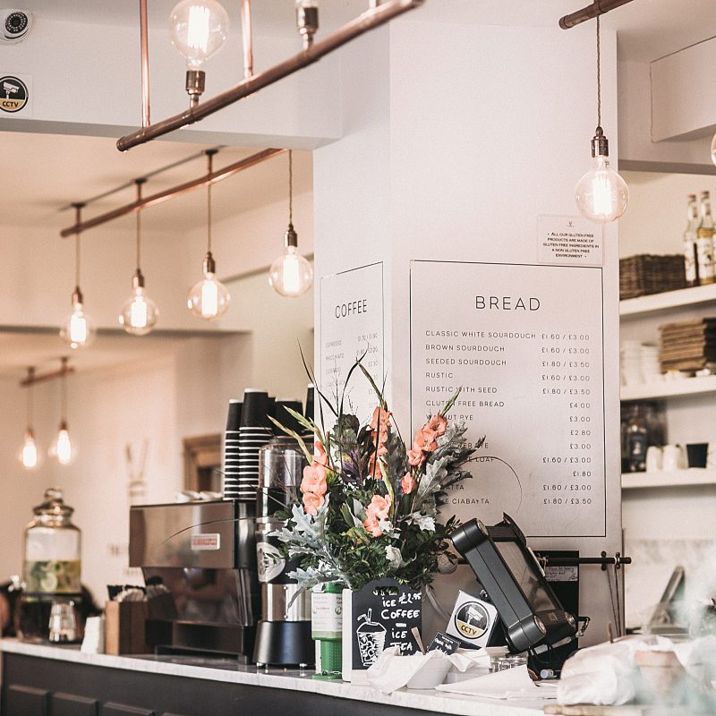 Canva Inside The Restaurant With Pendant Lamps And Flowers